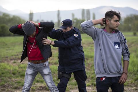 Migrants, who said they were from Syria, are being apprehended by the Serbian border police for having illegally entered the country from Macedonia, near the town of Presevo some 383 km (238 miles) from capital Belgrade, Serbia, April 29, 2015. PHOTO BY REUTERS/Marko Djurica