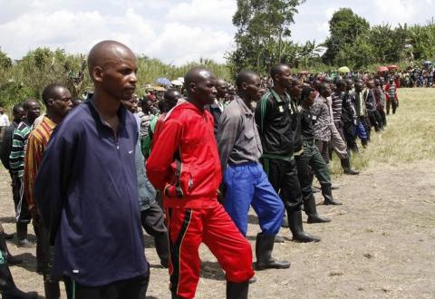 Militants from the Democratic Forces for the Liberation of Rwanda (FDLR) stand in line after surrendering in Kateku, a small town in eastern region of the Democratic Republic of Congo (DRC), May 30, 2014. PHOTO BY REUTERS/Kenny Katombe