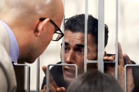 Mohammed Ali Malek (R) speaks with his lawyer Massimo Ferrante at Catania's tribunal, April 24, 2015. PHOTO BY REUTERS/Antonio Parrinello