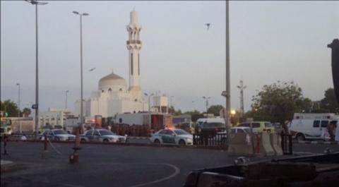General view of security personnel in front of a mosque as police stage a second controlled explosion, after a suicide bomber was killed and two other people wounded in a blast near the U.S. consulate in Jeddah, Saudi Arabia, in this still frame taken from video July 4, 2016. PHOTO BY REUTERS
