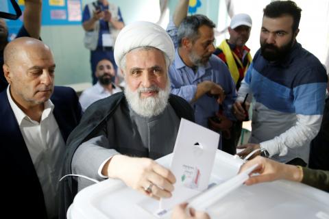 Lebanon's Hezbollah deputy leader Sheikh Naim Qassem casts his vote as he stands next to Hezbollah parliament candidate Amin Sherri at a polling station during the parliamentary election, in Beirut, Lebanon, May 6, 2018. PHOTO BY REUTERS/Mohamed Azakir
