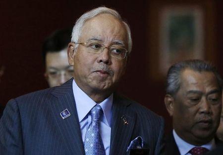 Malaysian Prime Minister Najib Razak arrives at a news conference to announce budget revisions to help its oil exporting economy adjust to the impact of slumping global crude prices, in Putrajaya, January 20, 2015. PHOTO BY REUTERS/Olivia Harris