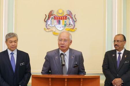 Malaysia's Prime Minister Najib Razak (C) announces the appointment of new Deputy Prime Minster Ahmad Zahid Hamidi (L) beside Malaysia's Chief Secretary to the Government Ali Hamsa (R) following a cabinet reshuffle in Putrajaya, Malaysia, July 28, 2015. PHOTO BY REUTERS/Mohd Fadli Hamzah