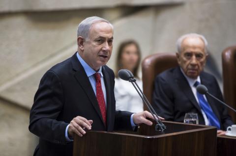 Israel's Prime Minister Benjamin Netanyahu (L) delivers a speech during a session marking the 65th anniversary of the Knesset, the Israeli parliament, in Jerusalem