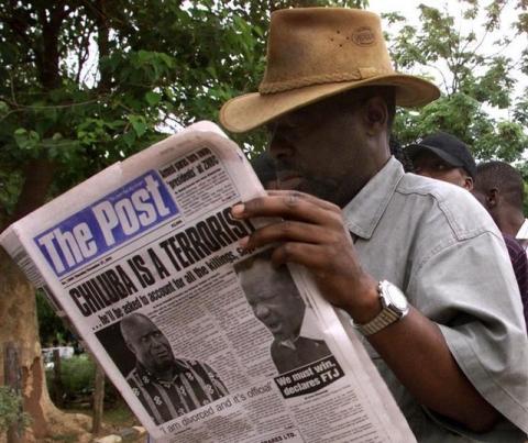 Zambian man reads a newspap in Lusaka. PHOTO BY REUTERS/Juda Ngwenya