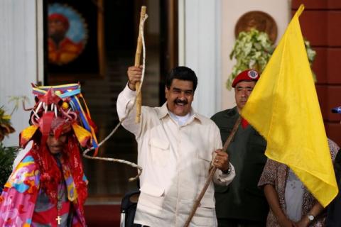 Venezuela's President Nicolas Maduro (C) holds a whip during a rally with supporters of African descent at Miraflores Palace in Caracas, Venezuela, June 21, 2016. PHOTO BY REUTERS/Carlos Garcia Rawlins