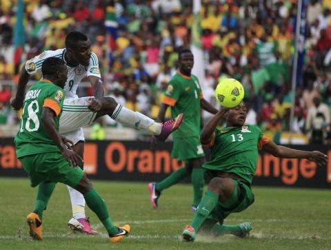 Nigeria's Emmanuel Emenike (2nd L) is challenged by Zambia's Stopilla Sunzu (R) and Emmanuel Mbola during their African Nations Cup (AFCON 2013) Group C soccer match in Nelspruit