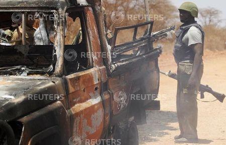 Security officers guard a police car, which was burnt during an attack on a convoy escorting Mandera governor Ali Roba, outside Mandera town, near Kenya's border with Somalia and Ethiopia, March 13, 2015. PHOTO BY REUTERS/Stringer