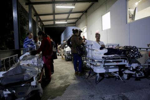Patients and family members are seen outside the Institute for Social Security and Services for State Workers (ISSSTE) after an earthquake struck off the southern coast of Mexico late on Thursday, in Puebla, Mexico, September 8, 2017. PHOTO BY REUTERS/Imelda Medina