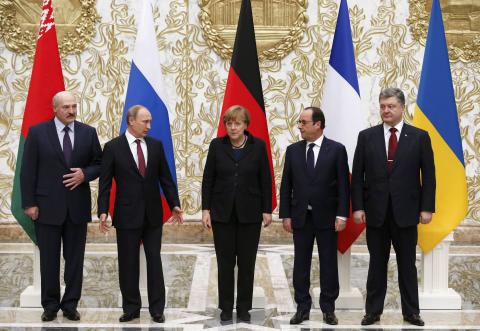 Belarus' President Alexander Lukashenko (L), Russia's President Vladimir Putin (2nd L), Ukraine's President Petro Poroshenko (R), Germany's Chancellor Angela Merkel (C) and France's President Francois Hollande pose for a family photo during peace talks in Minsk, February 11, 2015. PHOTO BY REUTERS/Grigory Dukor