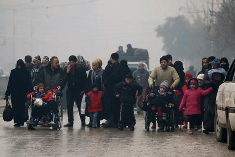 People walk as they flee deeper into the remaining rebel-held areas of Aleppo, Syria, December 13, 2016. PHOTO BY REUTERS/Abdalrhman Ismai