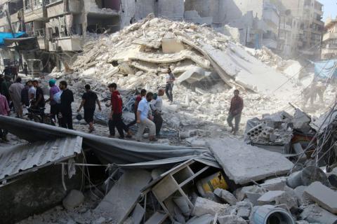 People inspect the damage at a market hit by airstrikes in Aleppo's rebel held al-Fardous district, Syria, October 12, 2016. PHOTO BY REUTERS/Abdalrhman Ismail