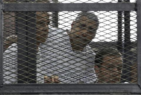Peter Greste, Mohamed Fahmy and Baher Mohamed (L-R) listen to the ruling at a court in Cairo, June 23, 2014. PHOTO BY REUTERS/Asmaa Waguih