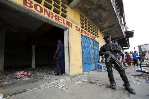 A police officer stands guard in front of a store that was looted during violent protests in Kinshasa, Democratic Republic of Congo, January 23, 2015. PHOTO BY REUTERS/Rey Byhre