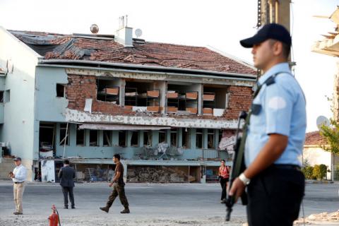 An armed policeman stands at the gate to the Turkish police special forces base damaged by fighting during a coup attempt in Ankara,Turkey, July 19, 2016. PHOTO BY REUTERS/Baz Ratner