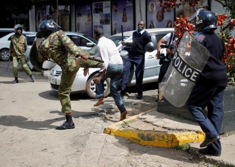 Kenyan policemen beat a protester during clashes in Nairobi, Kenya, May 16, 2016. PHOTO BY REUTERS/Goran Tomasevic