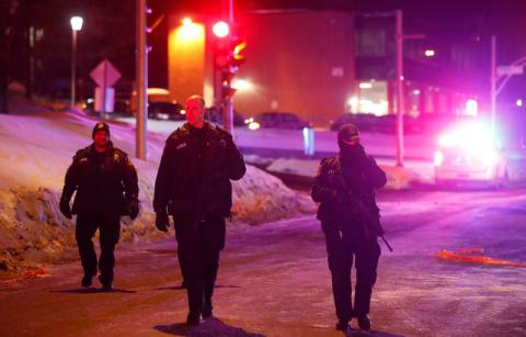 Police officers patrol the perimeter near a mosque after a shooting in Quebec City, January 29, 2017. PHOTO BY REUTERS/Mathieu Belanger