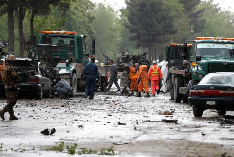 Afghan police and municipal workers clear debris from the site of a suicide bomb attack in Kabul, Afghanistan, May 3, 2017. PHOTO BY REUTERS/Omar Sobhani