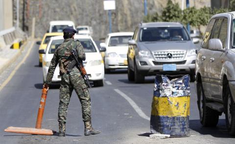 A police trooper stands at a checkpoint in Sanaa