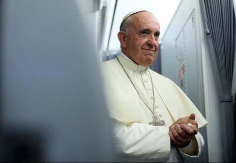 Pope Francis smiles onboard the papal plane during his return to Rome, from Asuncion, Paraguay July 12, 2015. Pope Francis left for Rome on Sunday at the end of a trip to South America. PHOTO BY REUTERS/Alessandro Bianchi