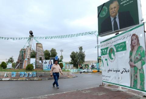 A man walks past a campaign poster ahead of the parliamentary election in Kirkuk, Iraq, May 11, 2018. PHOTO BY REUTERS/Ako Rasheed