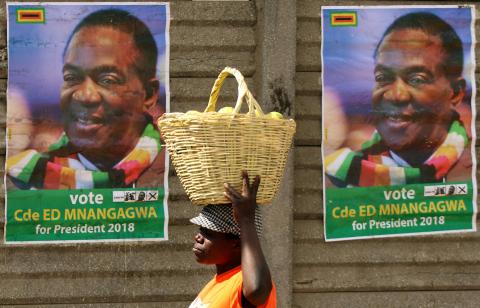 A street vendor carries fruit outside an election rally of President Emmerson Mnangagwa's ruling ZANU PF party in Mutare, Zimbabwe, May 19, 2018. PHOTO BY REUTERS/Philimon Bulawayo