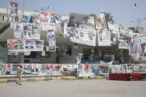 A soldier walks past posters of slain supporters of the separatist Southern Movement at a protest camp set up by the movement to demand the secession of south Yemen, in the southern port city of Aden, February 13, 2015. PHOTO BY REUTERS/Yaser Hasan