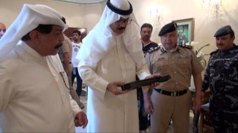 Kuwait's Deputy Prime Minister and Interior Minister Sheikh Mohammad al-Hamad al-Sabah (C) look at weapons that Kuwaiti authorities said were smuggled from Iran by suspected members of a militant cell in Kuwait August 13, 2015. PHOTO BY REUTERS/Kuwait News Agency