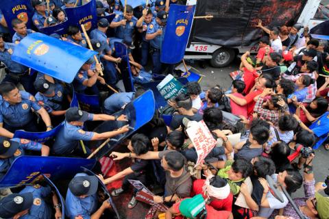 Various activist and Indigenous People's (IP) groups clash with anti-riot policemen during a protest against the continuing presence of U.S. troops in the Philippines in front of the U.S. Embassy in metro Manila, Philippines October 19, 2016. PHOTO BY REUTERS/Romeo Ranoco