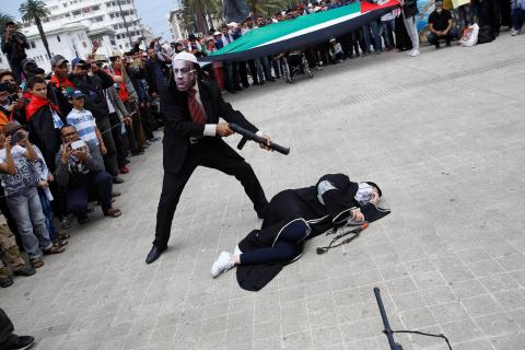 Pro-Palestinian protesters lie on the ground as they take part in a demonstration organized by Al Adl wal Ihsane, a Moroccan Islamist association, in solidarity with the Palestinian people, in Casablanca, Morocco, May 20, 2018. PHOTO BY REUTERS/Youssef Boudlal