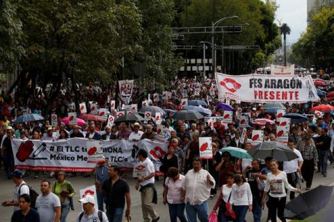 Union workers and farmers protest as NAFTA renegotiation begins in Washington, D.C., in Mexico City, Mexico August 16, 2017. The placards read " FTA hurts, Mexico better without FTA". PHOTO BY REUTERS/Carlos Jasso