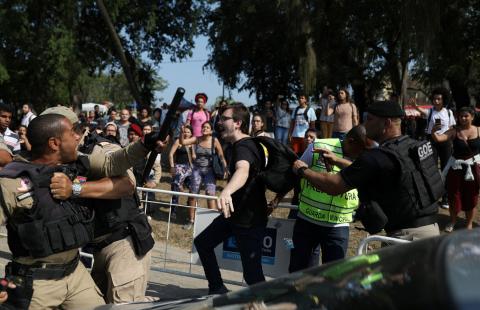 A demonstrator runs as municipal policeman controls his colleague during a protest in front of the National Museum of Brazil in Rio de Janeiro, Brazil, September 3, 2018. PHOTO BY REUTERS/Pilar Olivares