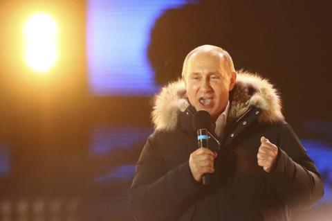 Russian President and Presidential candidate Vladimir Putin delivers a speech during a rally and concert marking the fourth anniversary of Russia's annexation of the Crimea region, at Manezhnaya Square in central Moscow, Russia, March 18, 2018. PHOTO BY REUTERS/David Mdzinarishvili