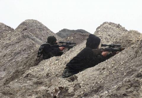 Rebel fighters take positions behind sand barricades at al-Breij frontline, after what they said was an advance by them in al-Manasher and al-Majbal areas, where forces loyal to Syria's President Bashar al-Assad were stationed, in Aleppo January 5, 2015. PHOTO BY REUTERS/Abdalghne Karoof