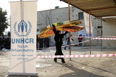 A Syrian refugee receives aid from the UN refugee agency (UNHCR) in Batroun, northern Lebanon, January 13, 2015. PHOTO BY REUTERS/Omar Ibrahim