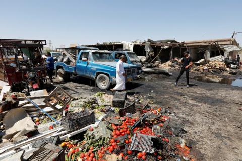 Residents gather at the site of car bomb attack in Rashidiya, a district north of Baghdad, Iraq, July 12, 2016. PHOTO BY REUTERS/Ahmed Saad