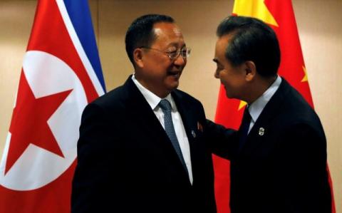 China's Foreign Minister Wang Yi (R) greets North Korea's Foreign Minister Ri Yong Ho before their bilateral meeting on the sidelines of the 50th Association of Southeast Asia Nations (ASEAN) Regional Forum (ARF) in Manila, Philippines, August 6, 2017. PHOTO BY REUTERS/Joe Campbell