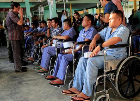 Philippines' President Rodrigo Duterte salutes a wounded soldier, who fights against the insurgents of the Maute group, which has taken over large parts of the Marawi city, during his visit at the military camp hospital in Cagayan De Oro, Philippines, June 11, 2017. PHOTO BY REUTERS/Romeo Ranoco