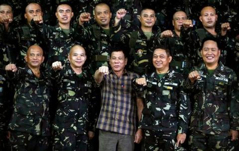 Philippine President Rodrigo Duterte makes a "fist bump", his May presidential elections campaign gesture, with soldiers during a visit at Capinpin military camp in Tanay, Rizal in the Philippines, August 24, 2016. PHOTO BY REUTERS/Erik De Castro