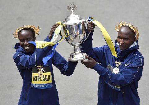 Boston Marathon women's division winner Edna Kiplagat, of Kenya, and men's division winner Geoffrey Kirui, also of Kenya, hold the trophy during the 121st Boston Marathon in Boston, Massachusetts, U.S., April 17, 2017. PHOTO BY REUTERS/Gretchen Ertl
