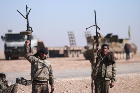 Syrian Democratic Forces (SDF) fighters hold up their weapons in the north of Raqqa city, Syria, February 3, 2017. PHOTO BY REUTERS/Rodi Said