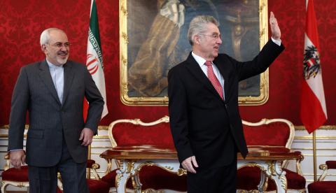 Austrian President Heinz Fischer (R) waves as he receives Iranian Foreign Minister Ali Akbar Salehi in his office in Vienna