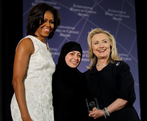 U.S. Secretary of State Hillary Clinton and First lady Michelle Obama (L) congratulate Samar Badawi of Saudi Arabia during the State Department's 2012 International Women of Courage Award winners ceremony in Washington, March 8, 2012. PHOTO BY REUTERS/Gary Cameron