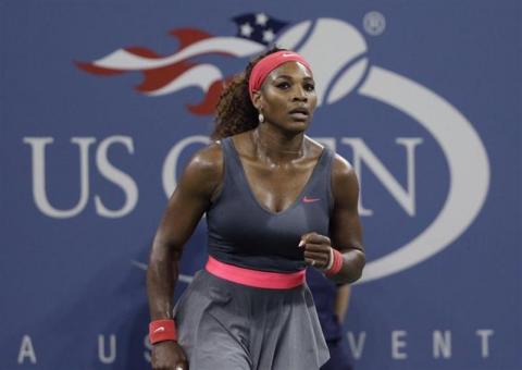 Serena Williams of the U.S. celebrates defeating Francesca Schiavone of Italy