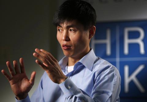 Human rights activist Shin Dong-hyuk gestures during a Reuters interview in Washington