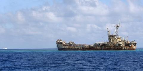 A Chinese Coastguard vessel patrols near the BRP Sierra Madre, a marooned transport ship which Philippine Marines live on as a military outpost, in the disputed Second Thomas Shoal, part of the Spratly Islands in the South China Sea, March 30, 2014. PHOTO BY REUTERS/Erik De Castro