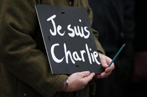 A man holds a 'Je suis Charlie' sign during a march for the victims of the shootings by gunmen at the offices of the satirical weekly newspaper Charlie Hebdo in Paris, in Liverpool, northern England, January 11, 2015. PHOTO BY REUTERS/Phil Noble