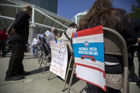 Signs are pictured during a voter registration drive for National Voter Registration Day outside Convention Center in Los Angeles, California, September 22, 2015. PHOTO BY REUTERS/Mario Anzuoni 