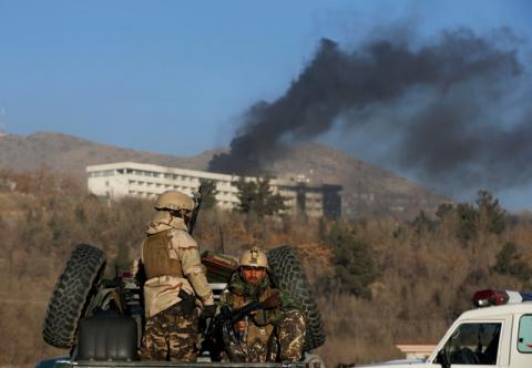 Afghan security forces keep watch as smoke rises from the Intercontinental Hotel in Kabul, Afghanistan, January 21, 2018. PHOTO BY REUTERS/Omar Sobhani