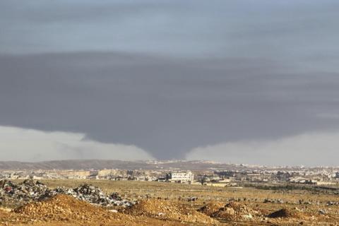 Smoke rises over the industrial city in Aleppo, Syria, February 4, 2016. PHOTO BY REUTERS/Abdalrhman Ismail
